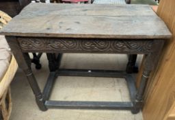 A 19th century oak side table with a rectangular planked top above a carved frieze on ring turned