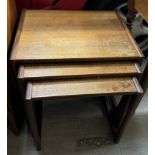 A mid-20th century teak nest of three tables,