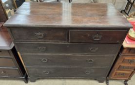 A 19th century oak chest with a rectangular planked top above two short and three long drawers on