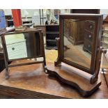 A Victorian mahogany toilet mirror with a rectangular plate above a shaped front on bun feet