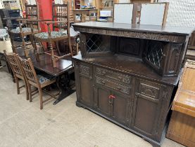 A 20th century dark oak dining suite comprising a refectory table,