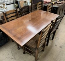 A 20th century oak dining suite comprising a dining table,