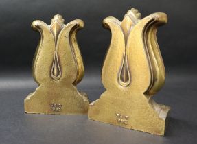 A pair of bronze book ends in the form of lyres on a rectangular base, moulded 56B PMC,
