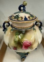 A Royal Worcester vase and cover, the cover with a twig handle and pierced top,
