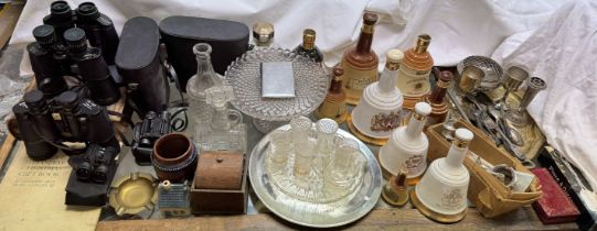 A collection of Bells Whisky decanters together with a brass tray, electroplated items, mincer,