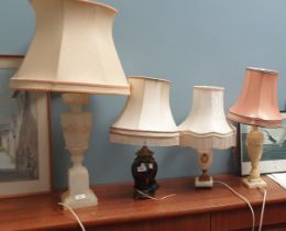 An onyx table lamp together with four other table lamps