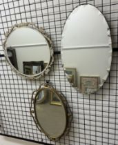 A cream painted wall mirror together with two other wall mirrors