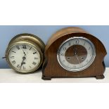 A brass bulk head timepiece with a white dial and Roman numerals together with a mantle clock