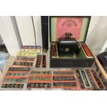 A Tin plate magic lantern and slides together with a quill tube and inkwell