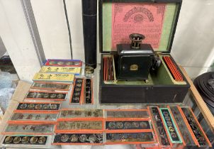 A Tin plate magic lantern and slides together with a quill tube and inkwell