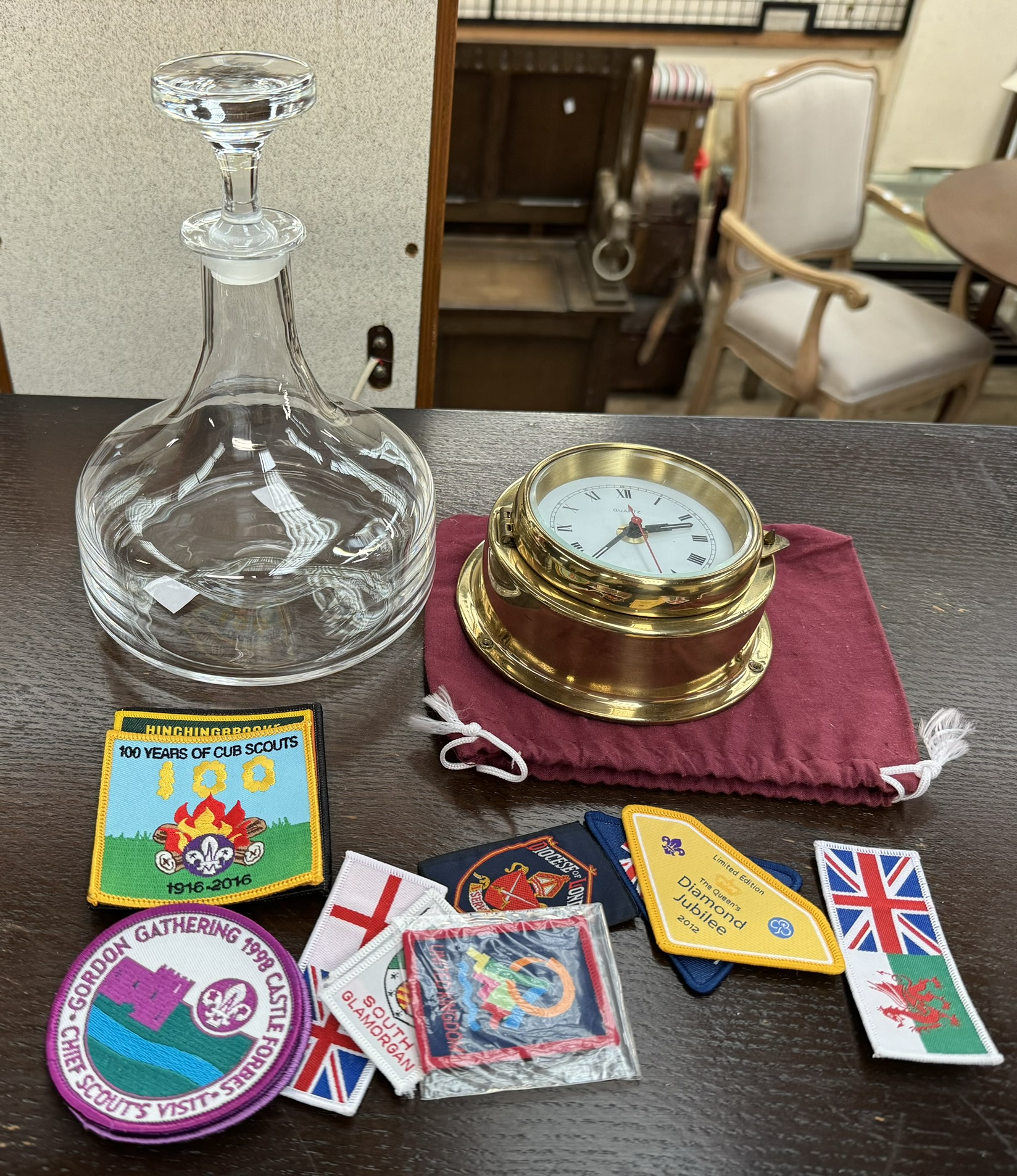 A decanter together with a quartz and brass clock,