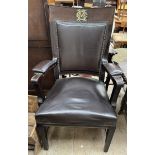 A captain's chair, with raised gilt monogram to a pad back,