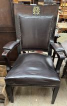 A captain's chair, with raised gilt monogram to a pad back,