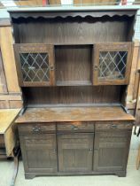 A 20th century oak dresser, the rack with a shelved and glazed top,