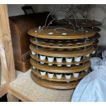 A pair of oak sectional three tier communion sets with electroplated handles and pottery beakers