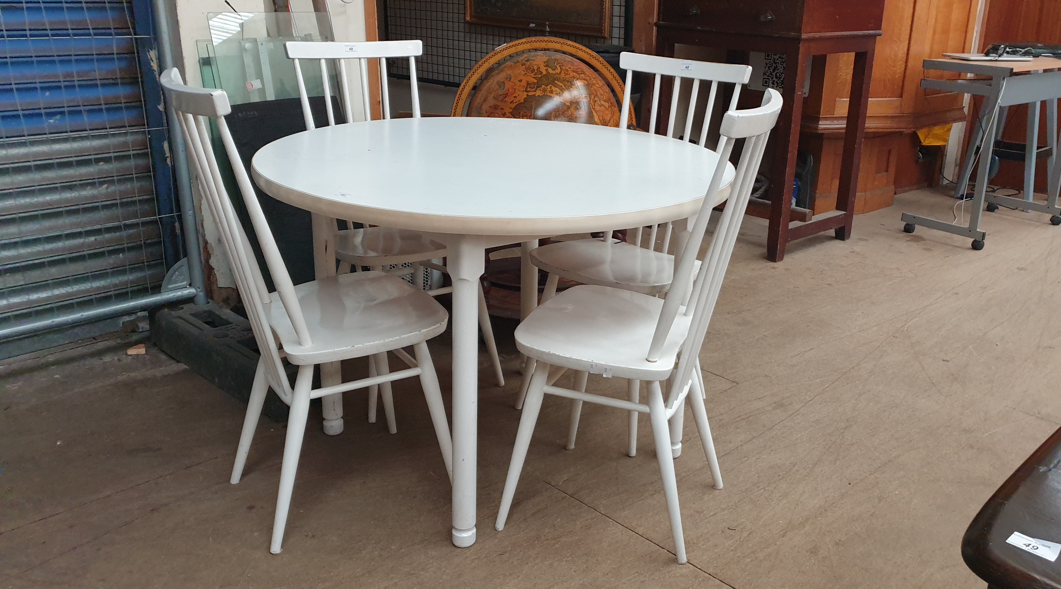 A mid 20th century white painted dining table and four chairs