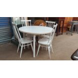 A mid 20th century white painted dining table and four chairs