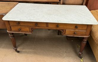 A Victorian marble topped washstand with drawers and tapering reeded legs