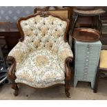 An upholstered library chair with a carved back, arms and legs together with a filing cabinet,