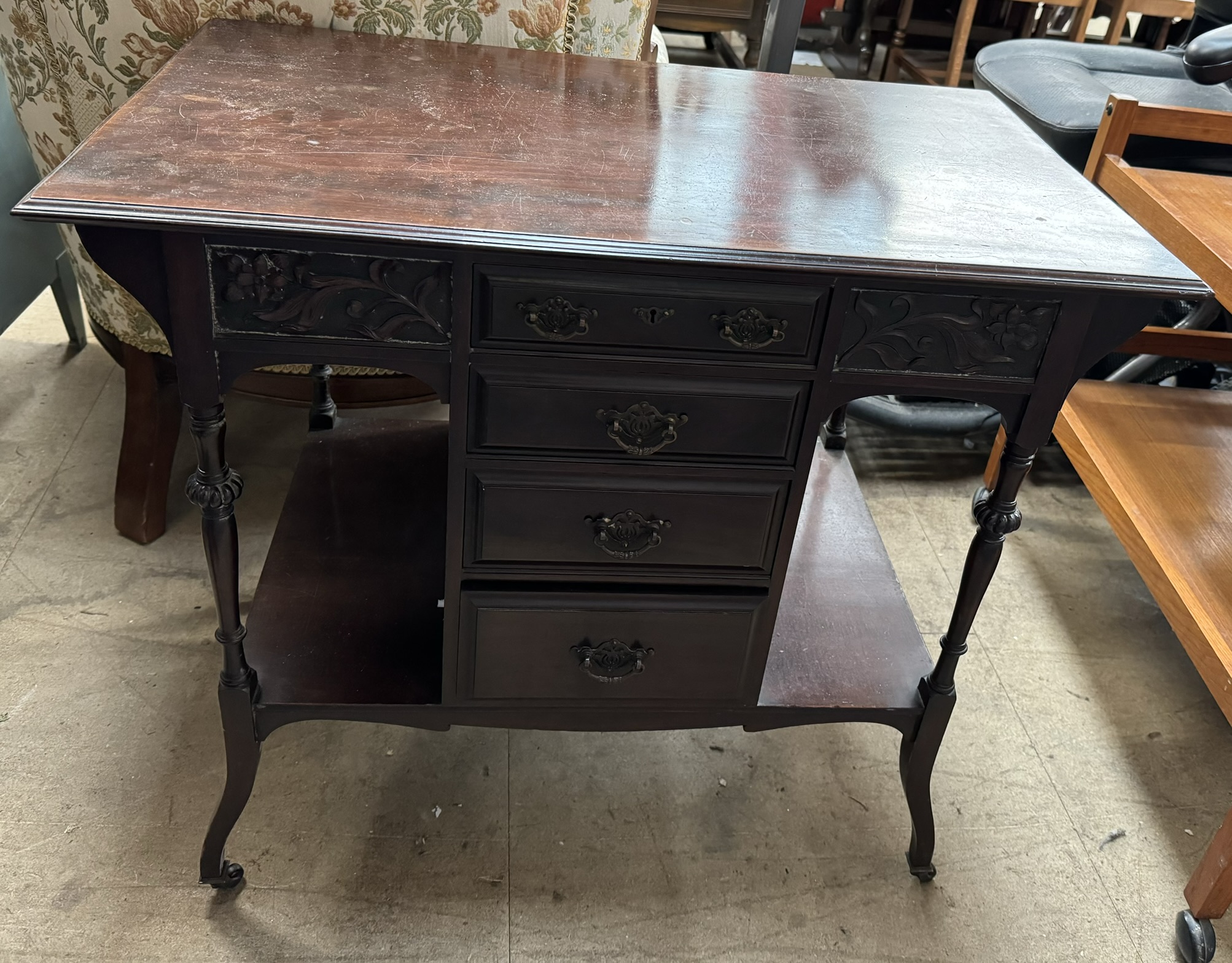 An Edwardian mahogany dressing table with a rectangular top above four drawers and shelves on