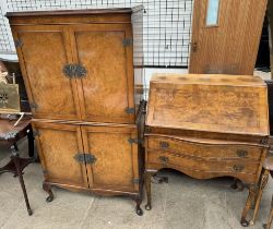 A 20th century walnut drinks cabinet on leaf capped cabriole legs and pointed pad feet together