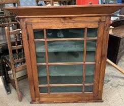 A pine hanging corner cupboard,