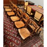 A matched set of twelve kitchen chairs with a bar back and solid seat