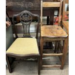 A 19th century mahogany dining chair with a wheel shaped back and drop in seat on square legs