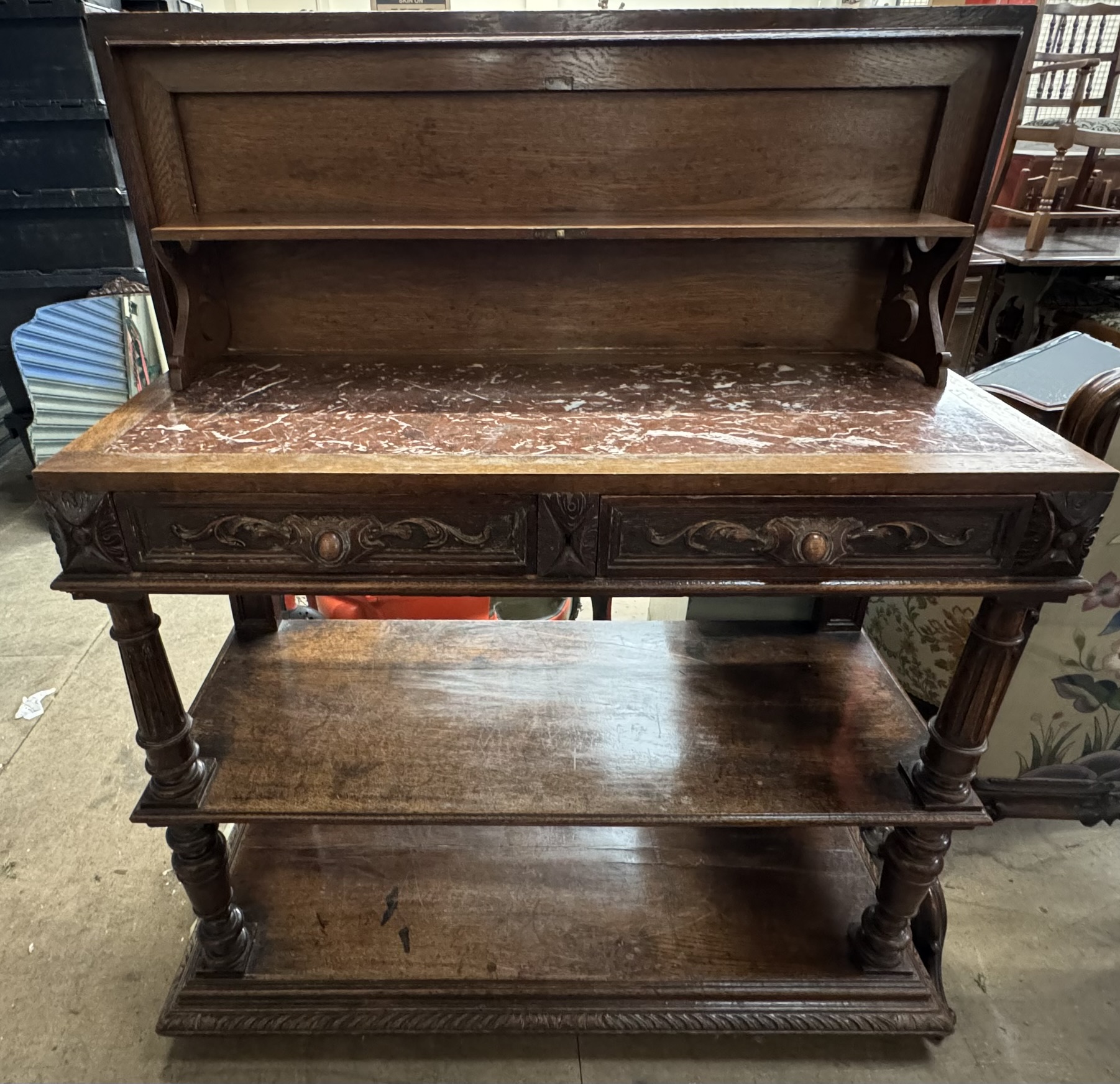 A 19th century oak low countries buffet with a hinged rectangular top enclosing a marble top and