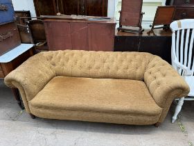 A Victorian Chesterfield settee on turned legs