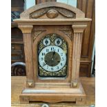 An early 20th century walnut cased bracket clock with a silvered dial and Arabic numerals,