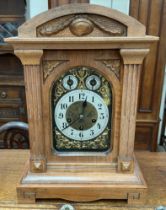 An early 20th century walnut cased bracket clock with a silvered dial and Arabic numerals,