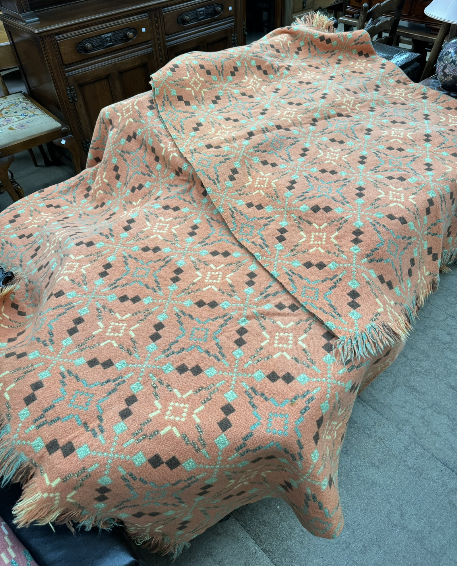 A pair of Welsh single blankets with an orange ground and brown,