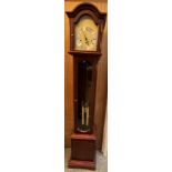 A Hermle Grandmother clock with a silvered dial and Roman numerals and a glazed door