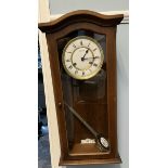 An Hermle mahogany framed wall clock