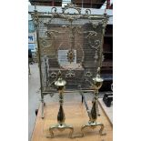 A brass fire screen with a fan shaped handle and grill together with a pair of brass andirons