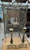 A brass fire screen with a fan shaped handle and grill together with a pair of brass andirons