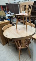 A 20th century pine dining table and four chairs