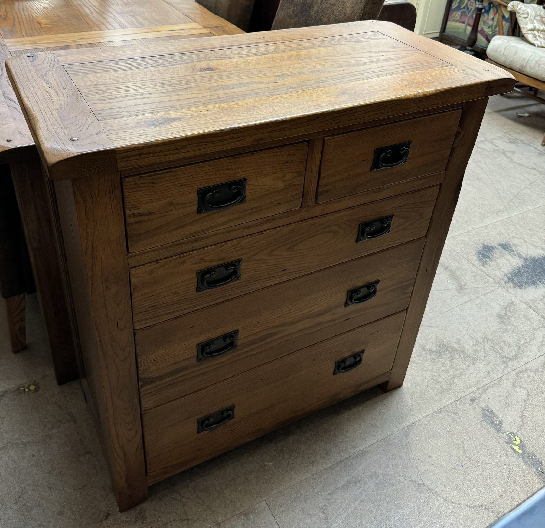 A modern oak chest with a rectangular top above two short and three long drawers on square legs