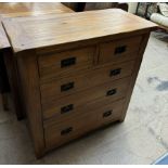 A modern oak chest with a rectangular top above two short and three long drawers on square legs