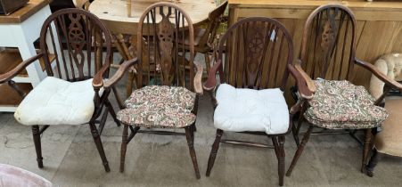 A pair of wheelback arm chairs together with another pair of wheelback armchairs