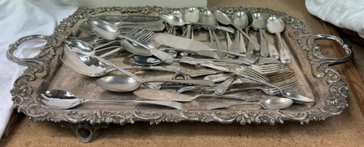 An electroplated twin handled tray with a scrolling leaf border together with assorted cutlery,