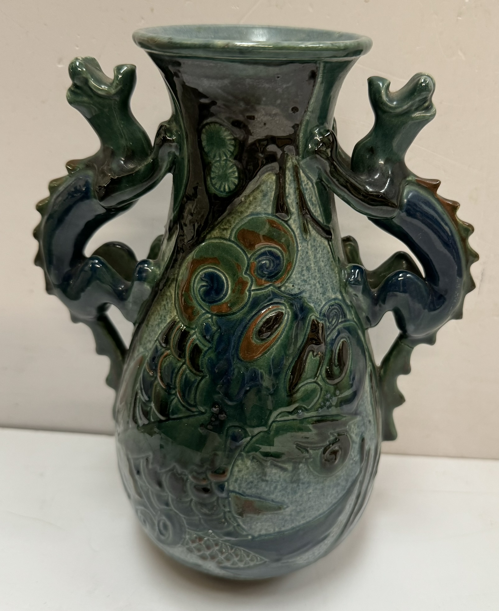 A G H Brannam twin dragon handled vase with incised fish decoration, inscribed to the base, 21.