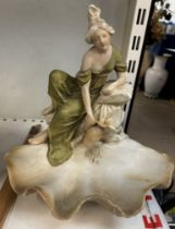 A Royal Dux figure of a maiden drawing water over a shell dish