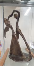 A bronze figure group of a dancing couple in the style of Henry Moore