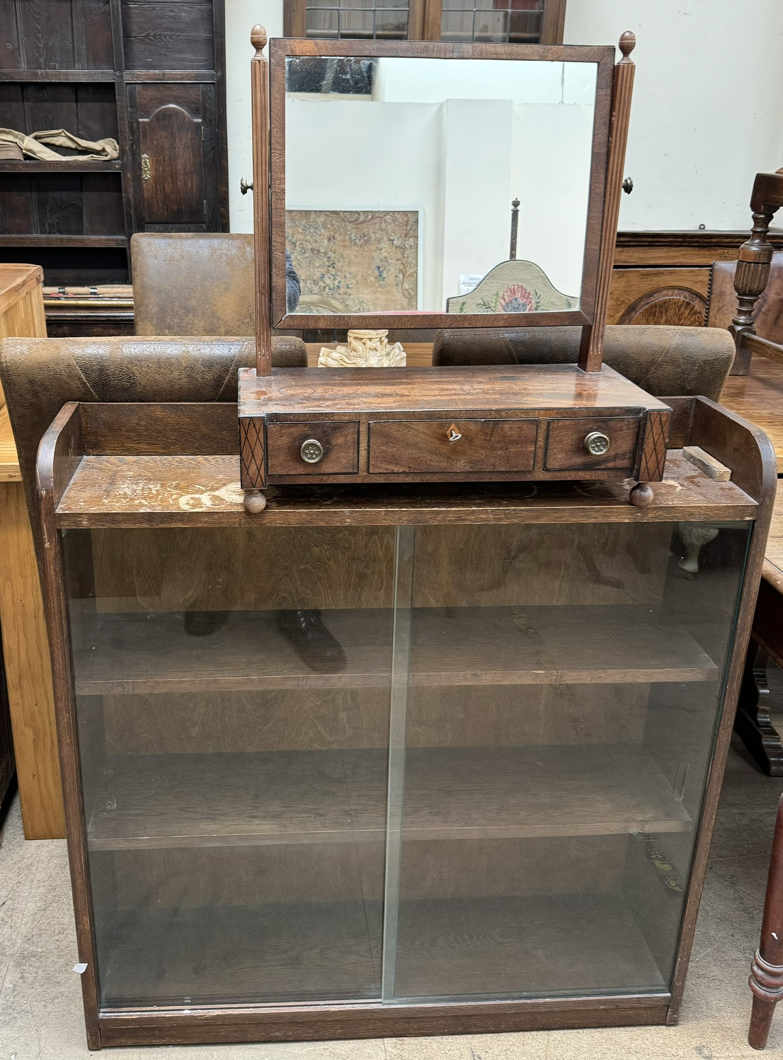 A 19th century mahogany toilet mirror with drawers to the base together with a glazed bookcase