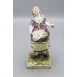 Fayence Figur einer Marktfrau / Apfelverkäuferin / A faience figure of a market woman offering ...