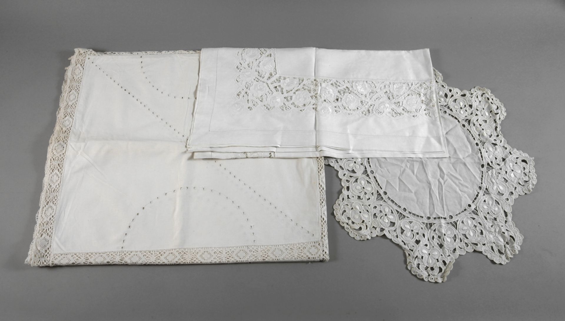 Three decorative blankets with white embroidery