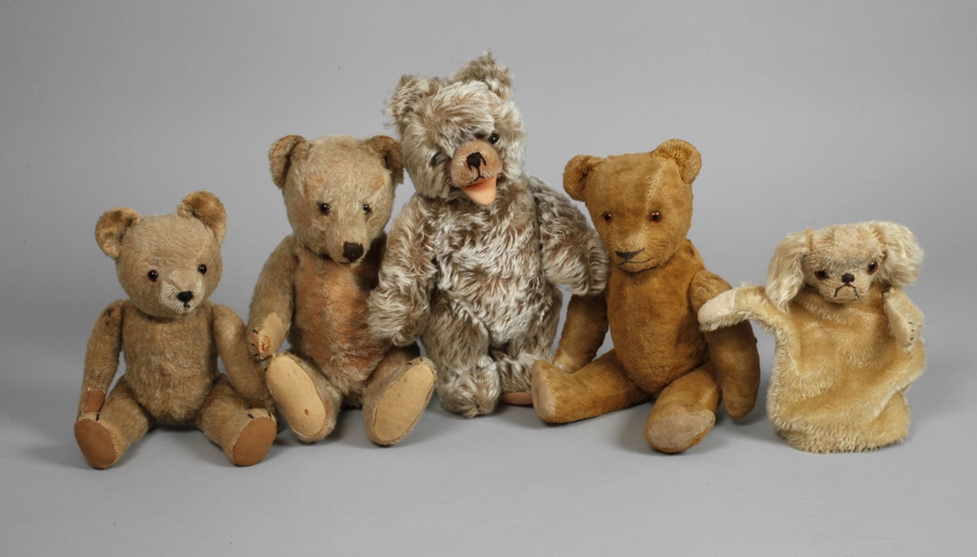 A collection of teddy bears and a Punch and Judy dog