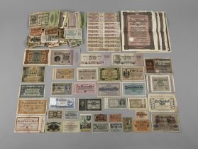 A collection of old banknotes, emergency money and shares
